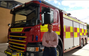 Neil next to a fire appliance